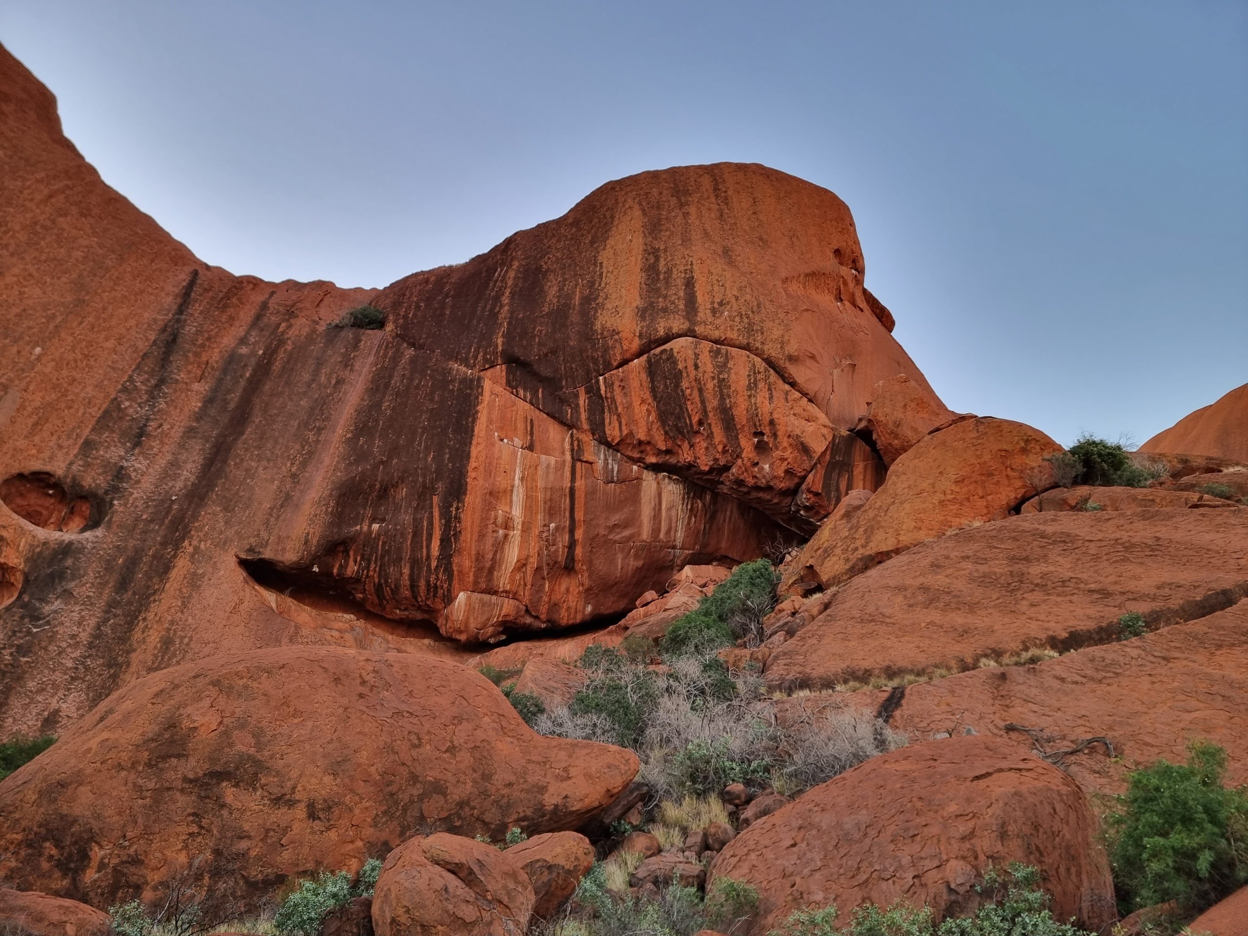 Learning about Anangu culture and traditions at the base of Uluru on the Kuniya Walk.