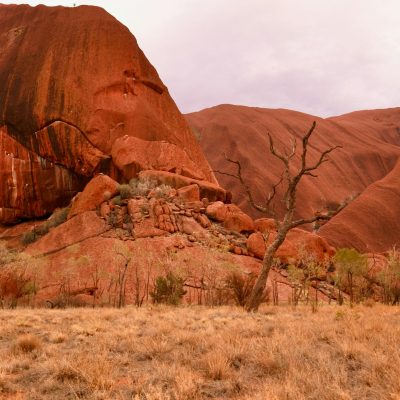A scenic view of the iconic red rock formation at Uluru, Australia.